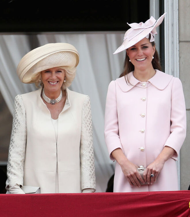 Com a duquesa da Cornualha no Palácio de Buckingham na cerimónia Trooping the Colour, que celebra o aniversário oficial da Rainha Isabel II. Este foi o último ato oficial da duquesa de Cambridge antes do nascimento do bebé. O casaco cor de rosa é da autoria de Sarah Burton para Alexander McQueen.