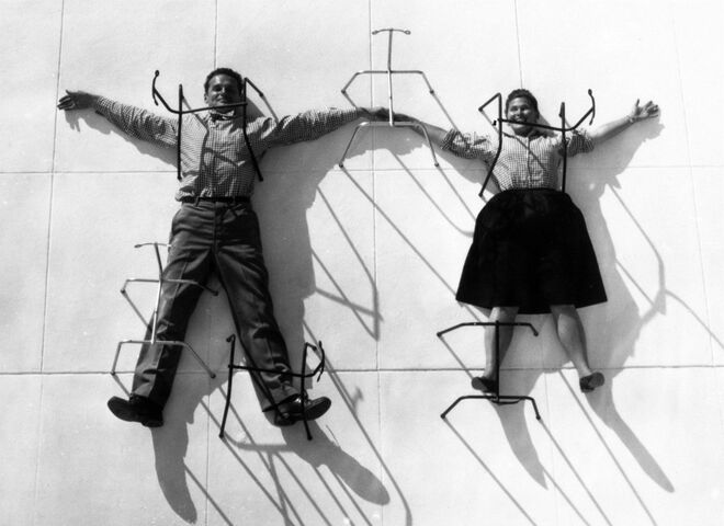The World of Charles and Ray Eames. Charles and Ray Eames posing with chair bases © Eames Office LLC