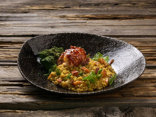 Na carta, destacam-se as vieiras braseadas com crocante de espargos e funcho do mar e da terra, pargo braseado com puré de topinambor, polvo na brasa com puré de batata-doce de Aljezur ou o salmonete braseado com ovo a baixa temperatura. Aqui, arroz de lavagante, um dos pratos da carta.