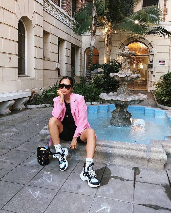 A autora de Song Of Style pousa num cenário idílico com os seus ténis chunky, num estilo que todas as bloggers de moda usaram: um blazer colorido com uns calções de bicicleta e um top justo pretos