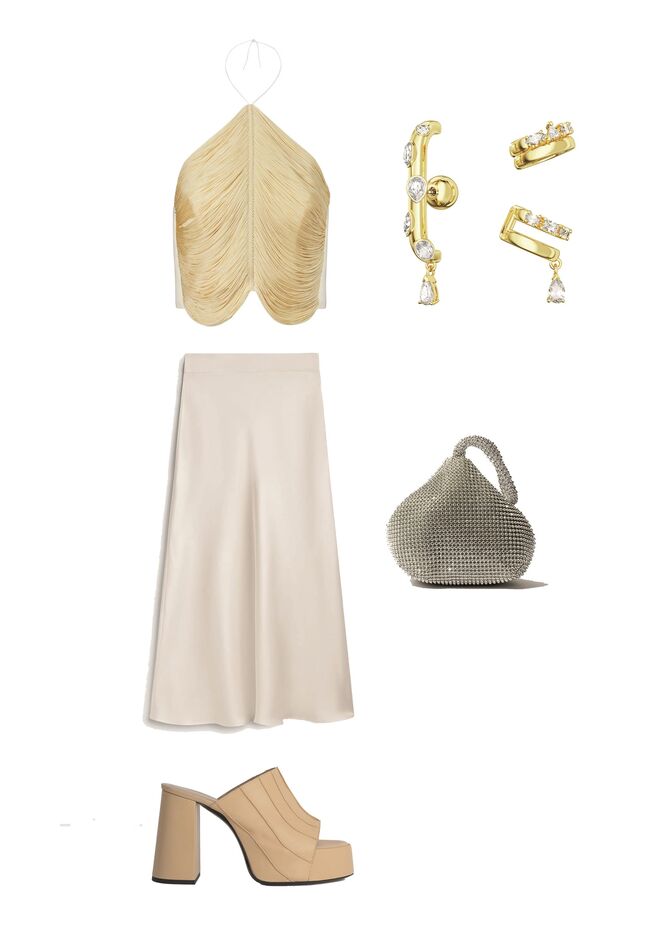 Top em cetim com franjas, €150, Mango Capsule. Saia em cetim, €99,95, Massimo Dutti Studio. Brincos cuff lacado a dourado com cristais, €135, Swarosvki. Carteira em tela com strass, €22,99, Sfera em El Corte Inglês. Sandálias em napa, €480, By Far.
