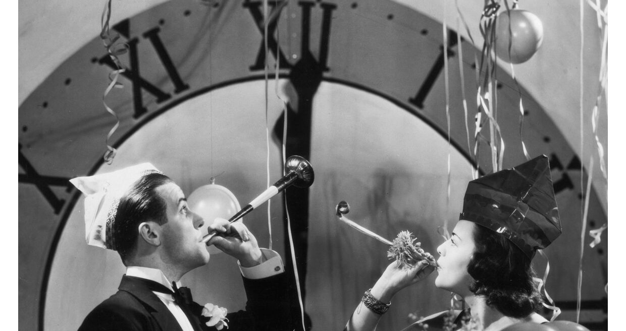 Celebração de ano novo com confetes, balões e um casal festivo